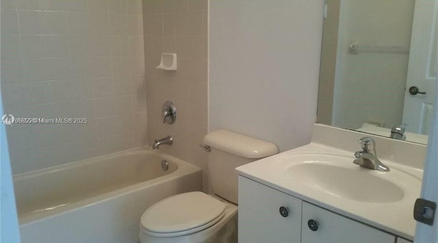 bathroom featuring toilet, vanity, and shower / tub combination