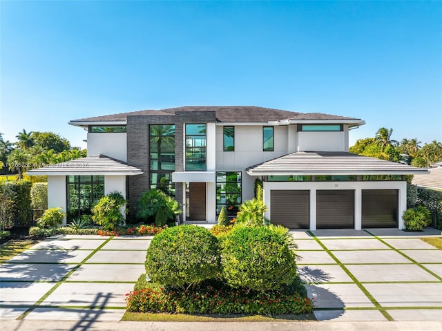 22 Isla Bahia Dr, Fort Lauderdale, FL 33316 - view of front of property with stucco siding, an attached garage, and concrete driveway