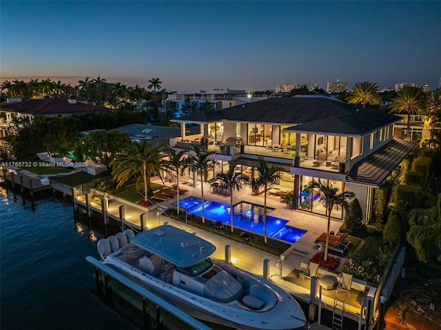 22 Isla Bahia Dr, Fort Lauderdale, FL 33316 - rear view of property featuring a balcony, a patio area, a water view, and an infinity pool