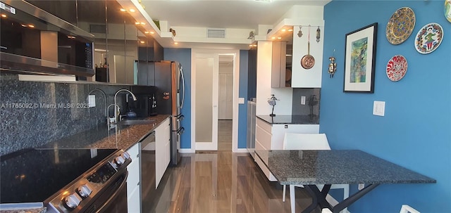 8530 Byron Ave Unit 502, Miami Beach, FL 33141 - kitchen featuring visible vents, wood finished floors, tasteful backsplash, a sink, and stainless steel appliances