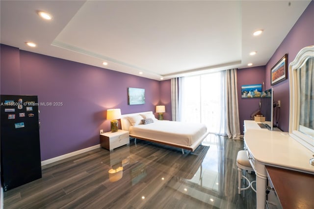 8530 Byron Ave Unit 502, Miami Beach, FL 33141 - bedroom featuring a raised ceiling, recessed lighting, expansive windows, and wood finished floors