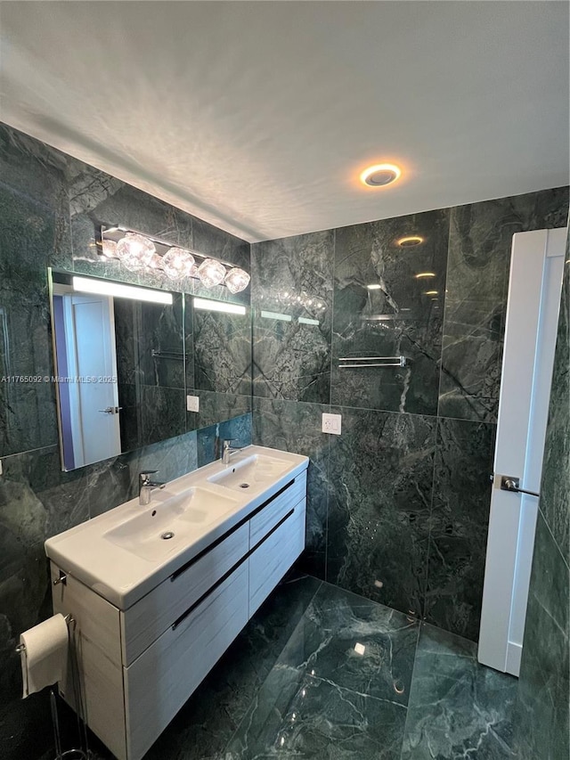 8530 Byron Ave Unit 502, Miami Beach, FL 33141 - bathroom featuring tile walls, double vanity, and marble finish flooring