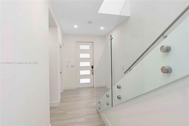 foyer featuring recessed lighting, baseboards, and light wood finished floors