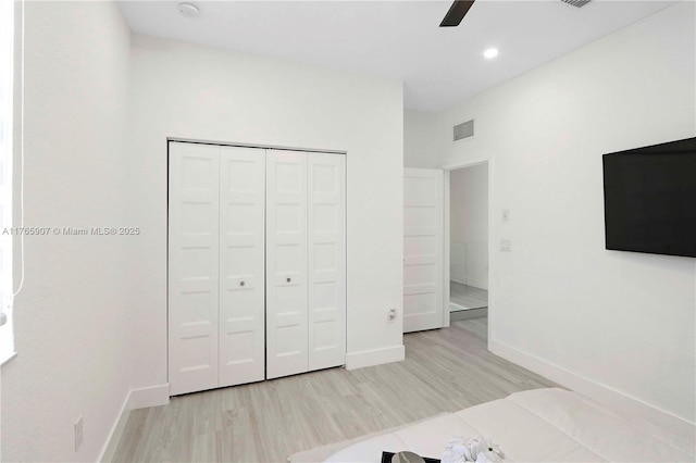 unfurnished bedroom featuring visible vents, baseboards, and light wood-style floors
