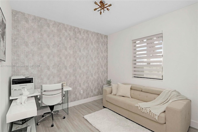 office space with wallpapered walls, wood finished floors, and baseboards