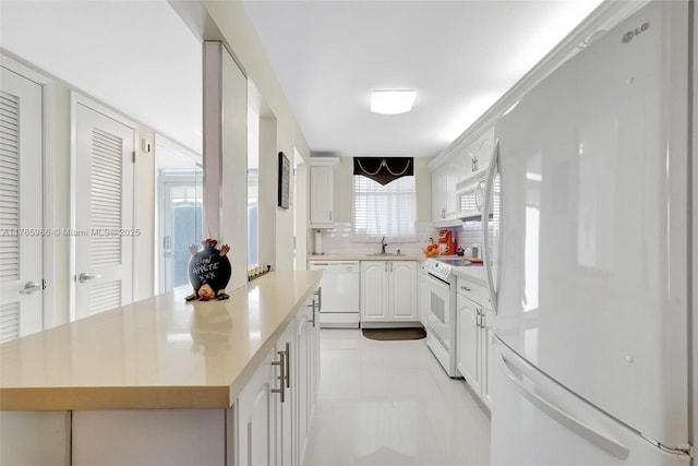 410 Golden Isles Dr Unit 603, Hallandale Beach, FL 33009 - kitchen featuring decorative backsplash, white appliances, white cabinetry, and light countertops