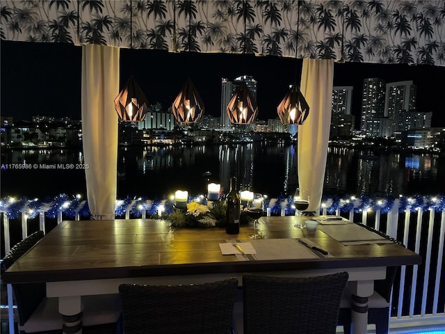 410 Golden Isles Dr Unit 603, Hallandale Beach, FL 33009 - dining room featuring wallpapered walls and a water view