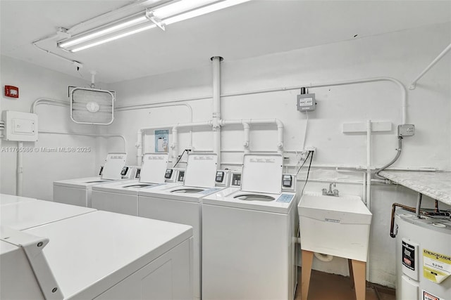 410 Golden Isles Dr Unit 603, Hallandale Beach, FL 33009 - common laundry area featuring a sink, separate washer and dryer, and electric water heater