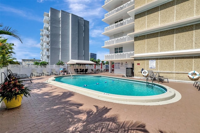 410 Golden Isles Dr Unit 603, Hallandale Beach, FL 33009 - community pool with a gazebo, fence, and a patio