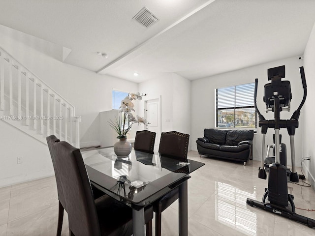 dining space with visible vents, stairs, and baseboards