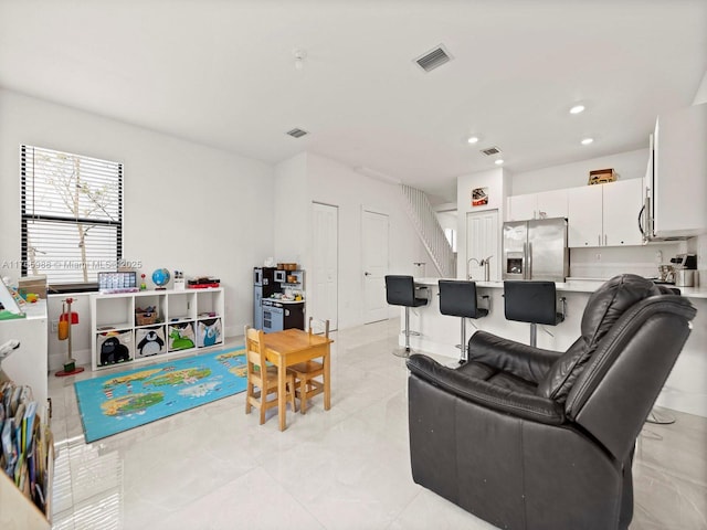 living room with visible vents and recessed lighting