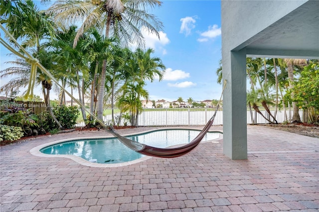 view of swimming pool with a fenced backyard, a patio, and a fenced in pool