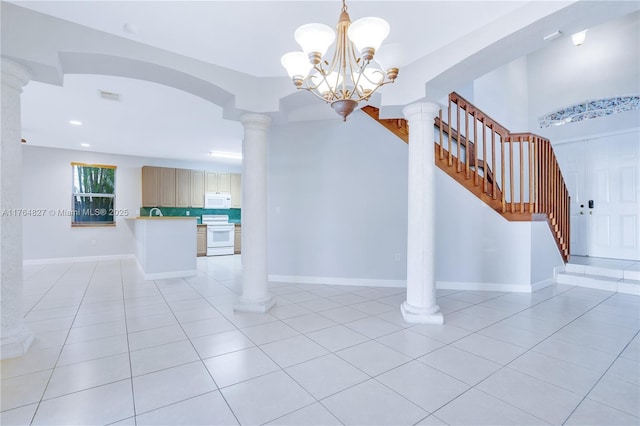 interior space featuring baseboards, visible vents, tile patterned floors, and a chandelier