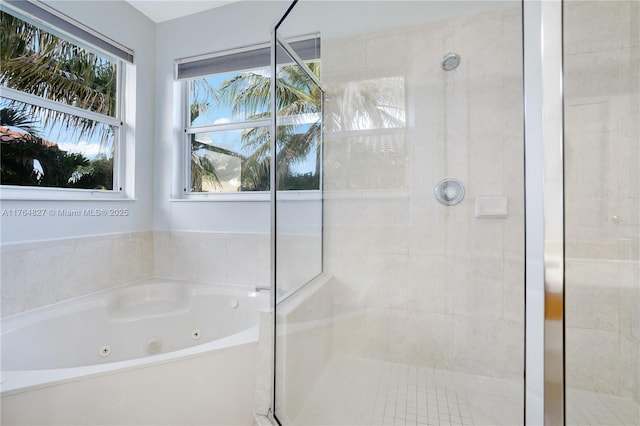 full bath featuring a stall shower and a tub with jets