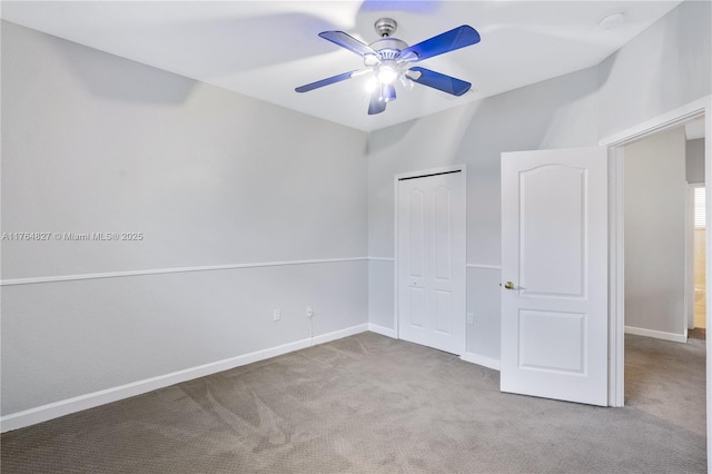 unfurnished bedroom with baseboards, carpet flooring, ceiling fan, and a closet
