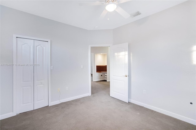 unfurnished bedroom featuring baseboards, visible vents, a closet, and carpet