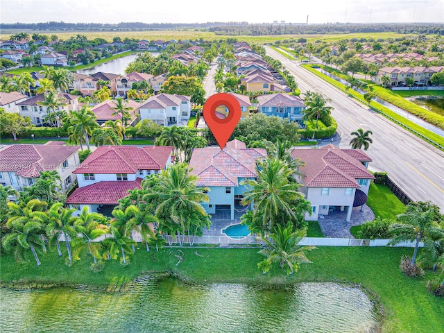 drone / aerial view with a residential view and a water view