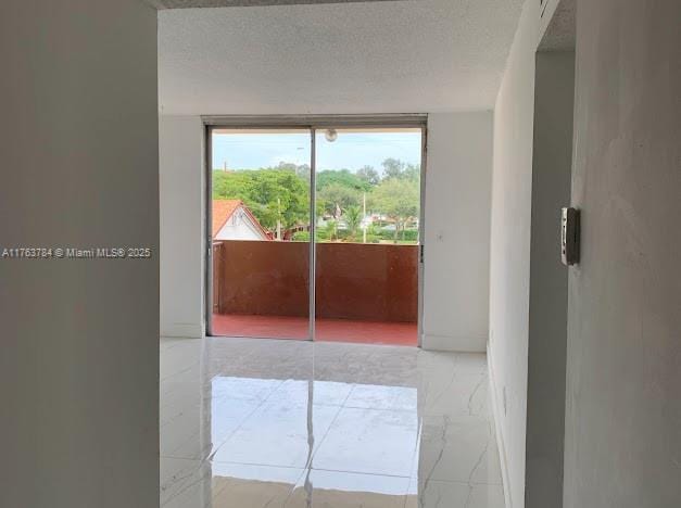 13390 NE 7th Ave Unit 308, North Miami, FL 33161 - interior space featuring baseboards, marble finish floor, and a textured ceiling
