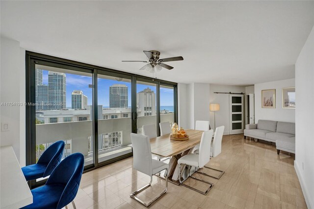 6820 Indian Creek Dr Unit 9A, Miami Beach, FL 33141 - dining space with a wall of windows, baseboards, a barn door, ceiling fan, and a view of city
