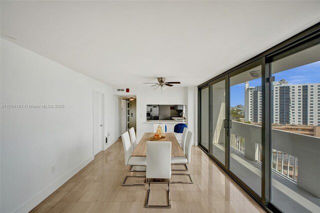 6820 Indian Creek Dr Unit 9A, Miami Beach, FL 33141 - dining space with baseboards, a wall of windows, ceiling fan, and a view of city