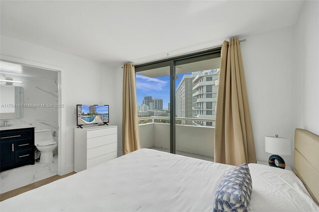 6820 Indian Creek Dr Unit 9A, Miami Beach, FL 33141 - bedroom featuring ensuite bathroom, a view of city, access to exterior, and marble finish floor