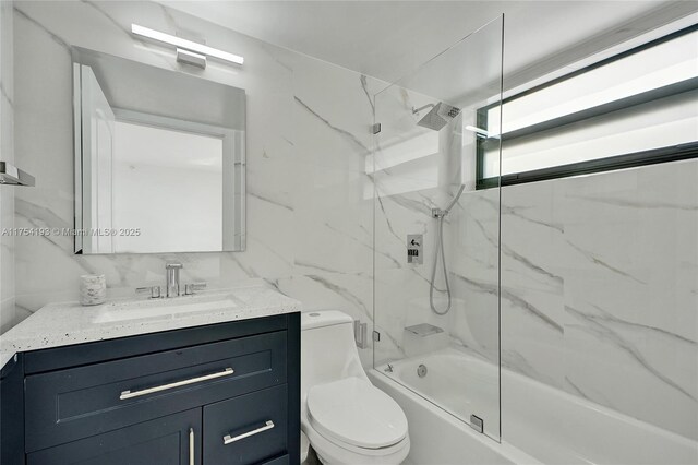 6820 Indian Creek Dr Unit 9A, Miami Beach, FL 33141 - full bathroom with toilet, vanity, tasteful backsplash, tub / shower combination, and tile walls