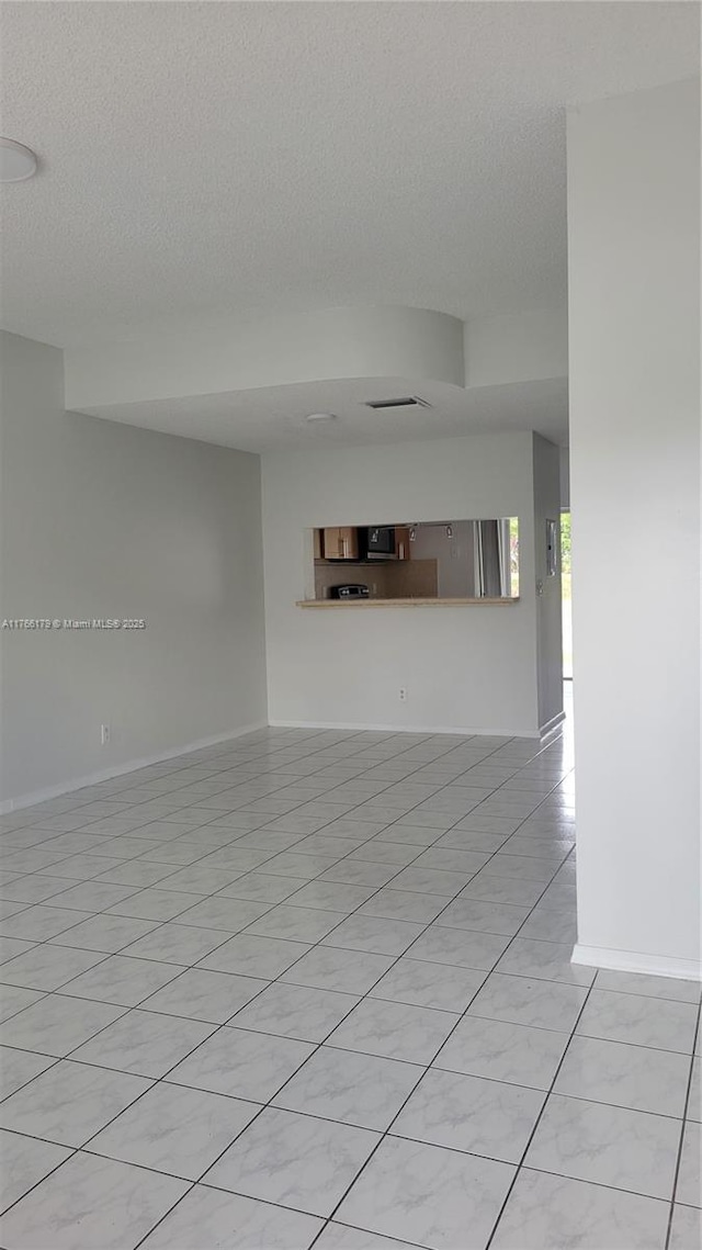 16731 Hemingway Dr, Weston, FL 33326 - unfurnished room featuring a textured ceiling, baseboards, and light tile patterned floors