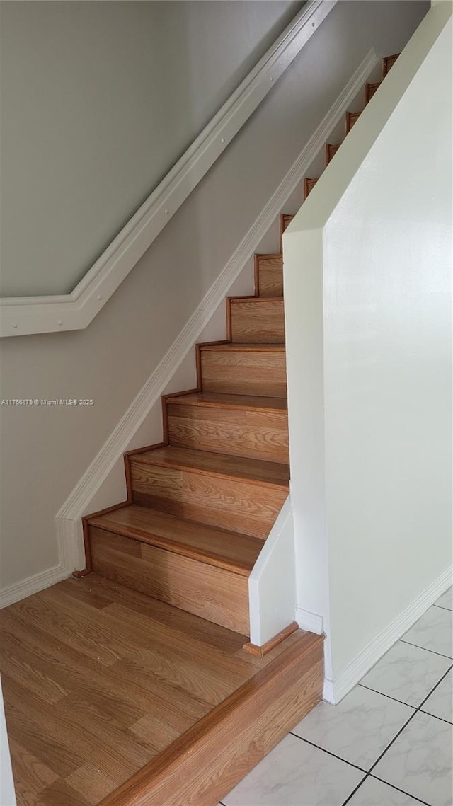 16731 Hemingway Dr, Weston, FL 33326 - stairway with marble finish flooring and baseboards