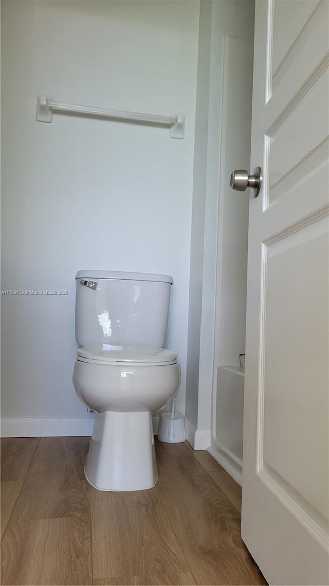 16731 Hemingway Dr, Weston, FL 33326 - bathroom featuring baseboards, toilet, and wood finished floors