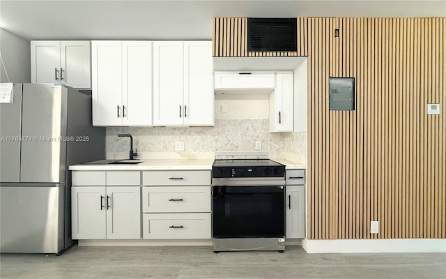 1770 E Las Olas Blvd Unit 302, Fort Lauderdale, FL 33301 - kitchen featuring electric range oven, freestanding refrigerator, white cabinets, light countertops, and light wood-style floors