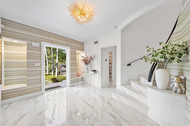 foyer featuring stairway, marble finish floor, baseboards, visible vents, and ornamental molding