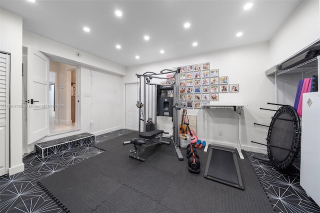 exercise room with baseboards and recessed lighting