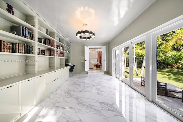 interior space with marble finish floor, baseboards, french doors, and a chandelier