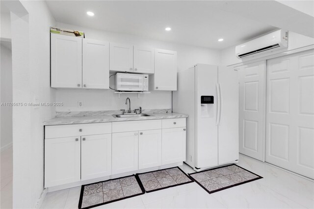 18650 SW 127th Ct, Miami, FL 33177 - kitchen with white appliances, an AC wall unit, white cabinetry, recessed lighting, and light stone counters
