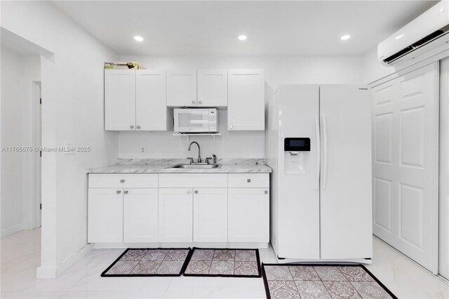 18650 SW 127th Ct, Miami, FL 33177 - kitchen featuring white appliances, an AC wall unit, white cabinets, recessed lighting, and light stone counters
