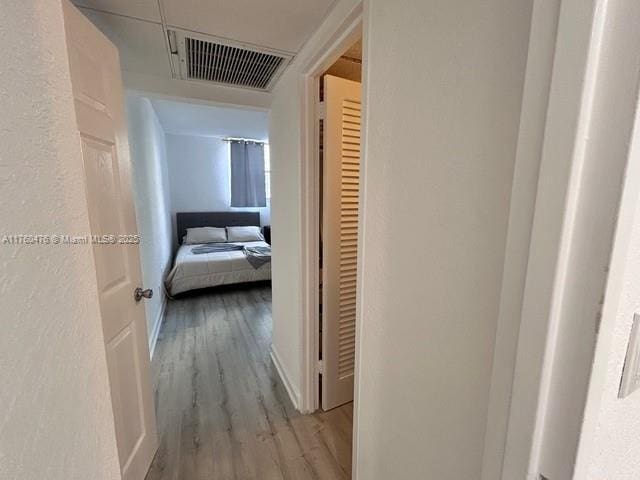hall with wood finished floors and visible vents