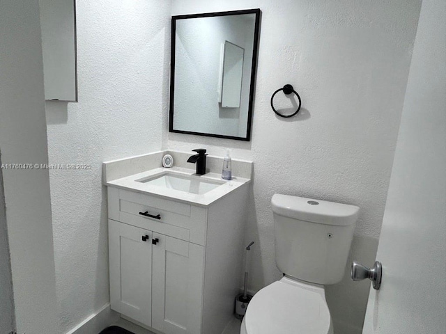 bathroom featuring toilet and a textured wall