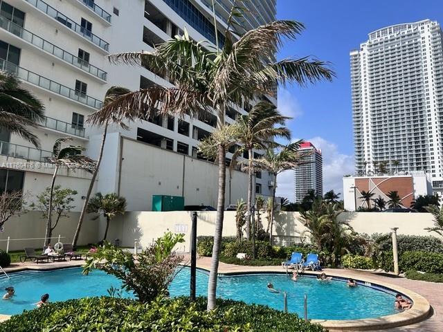 pool with a view of city and fence