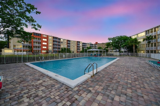 1710 NE 191st St Unit 315-3, Miami, FL 33179 - pool at dusk featuring a patio, a community pool, and fence