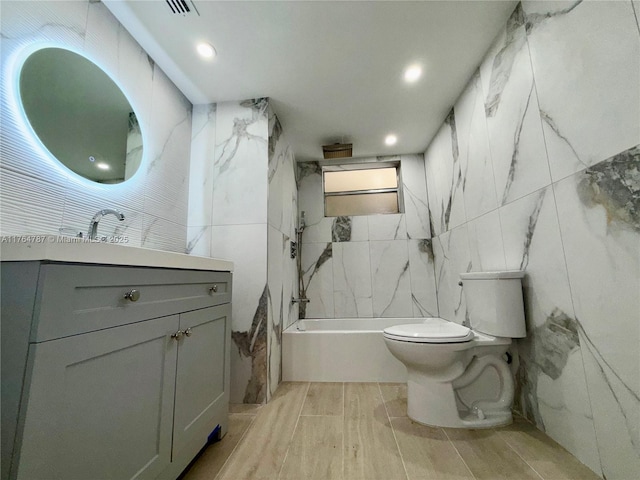 1710 NE 191st St Unit 315-3, Miami, FL 33179 - full bathroom featuring toilet, shower / bathing tub combination, vanity, tile walls, and wood tiled floor