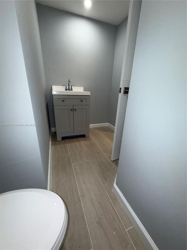 1710 NE 191st St Unit 315-3, Miami, FL 33179 - bathroom with wood finish floors, baseboards, and vanity
