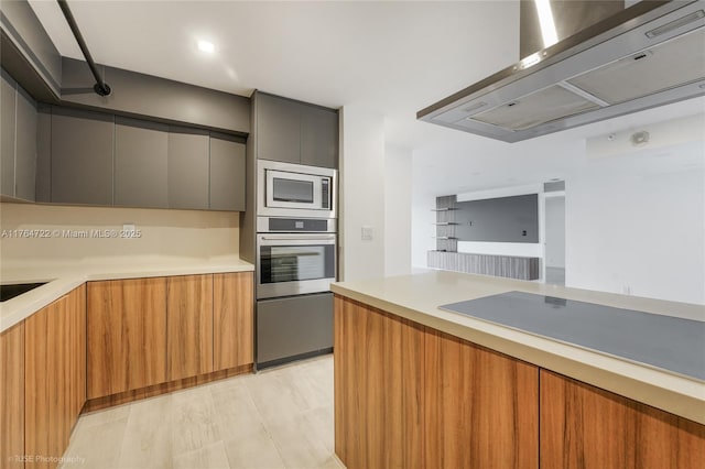 1000 Quayside Ter Unit 903, Miami, FL 33138 - kitchen featuring oven, built in microwave, light countertops, range hood, and modern cabinets