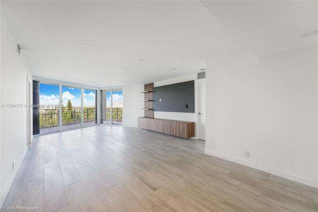 1000 Quayside Ter Unit 903, Miami, FL 33138 - spare room featuring floor to ceiling windows, baseboards, and light wood finished floors