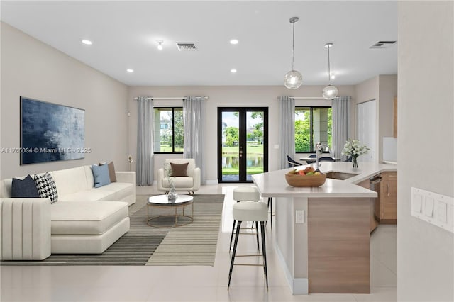 living room featuring visible vents, recessed lighting, light tile patterned floors, and french doors