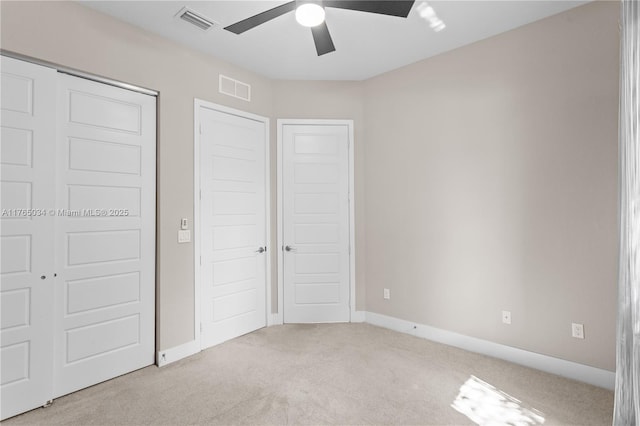 unfurnished bedroom featuring visible vents, carpet flooring, baseboards, and a ceiling fan