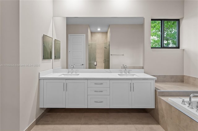 full bath with tile patterned flooring, a sink, a bath, and a stall shower