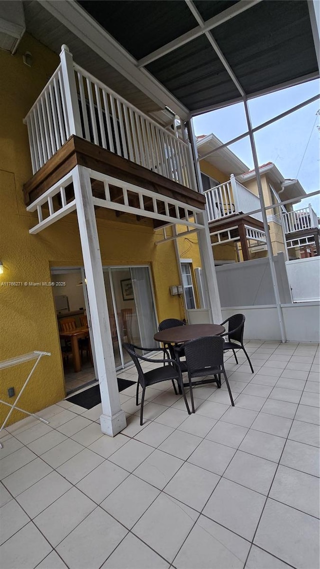 1013 Park Ridge Cir, Kissimmee, FL 34746 - view of patio with a lanai, a balcony, and outdoor dining area