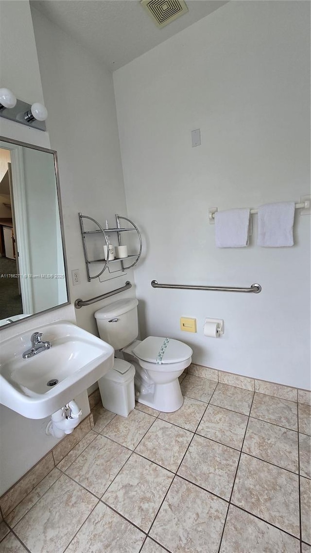 1013 Park Ridge Cir, Kissimmee, FL 34746 - bathroom featuring tile patterned flooring, toilet, visible vents, and a sink