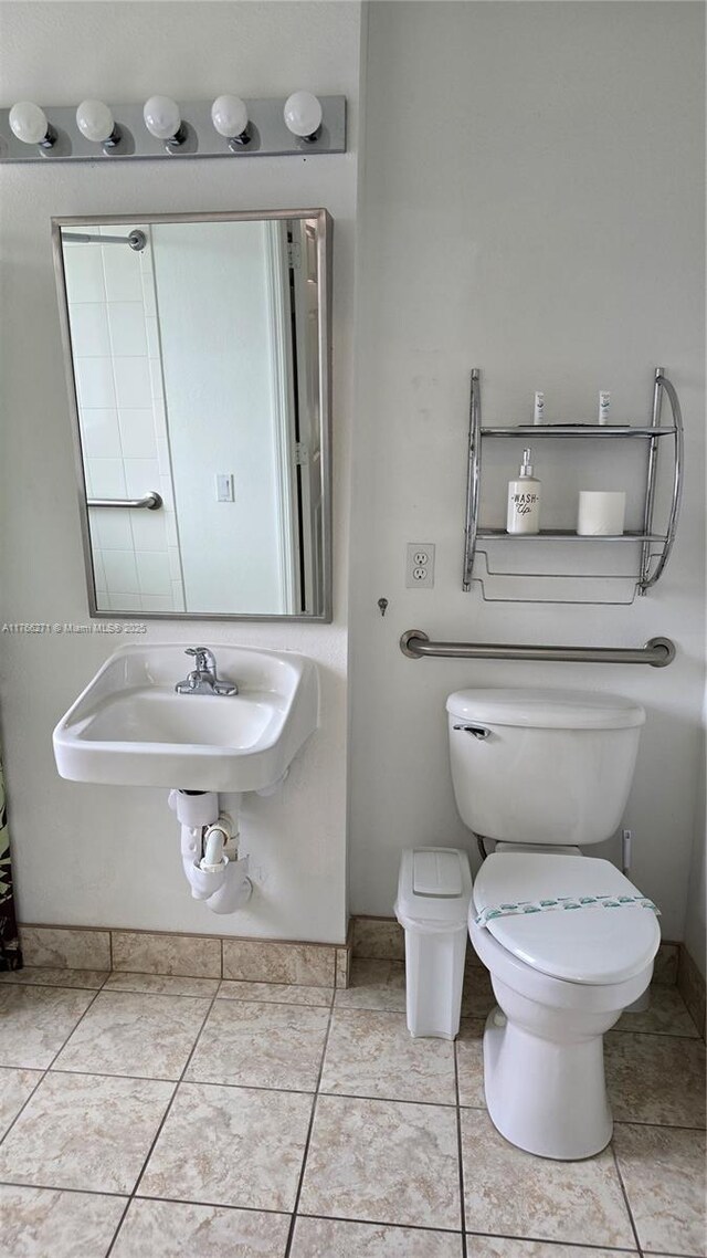 1013 Park Ridge Cir, Kissimmee, FL 34746 - bathroom featuring tile patterned flooring, toilet, and a sink