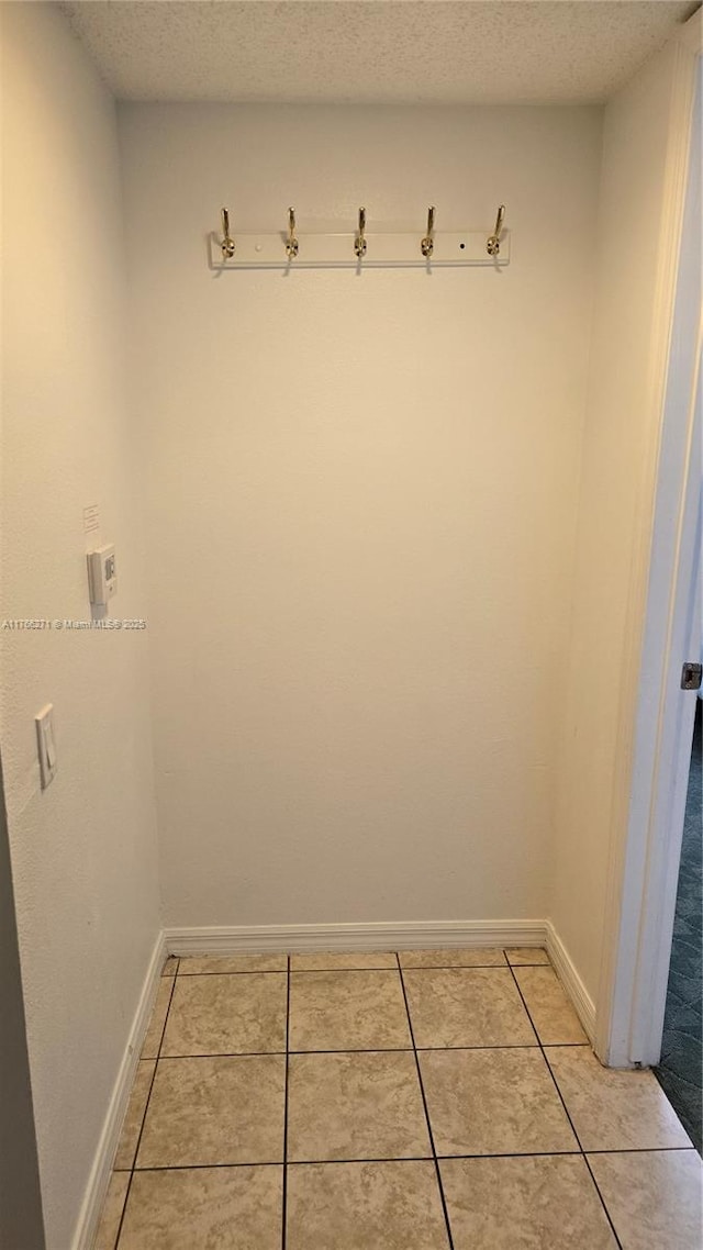 1013 Park Ridge Cir, Kissimmee, FL 34746 - interior space with light tile patterned floors, a textured ceiling, and baseboards
